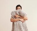 man hugging a bearaby weighted blanket.
