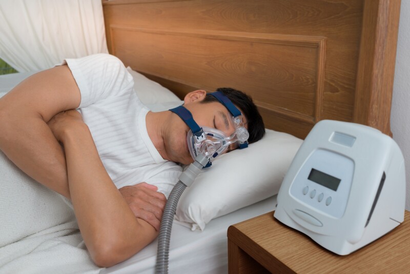 Man wearing a CPAP machine to sleep