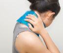 A woman holding an ice pack against her neck.