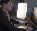 Man using a light box on his work desk