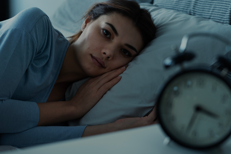 Insomniac young woman in bed