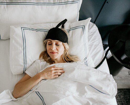 woman sleeping wearing a cooling headband