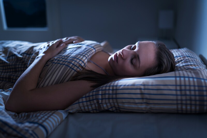 Person sleeping at night after taking melatonin