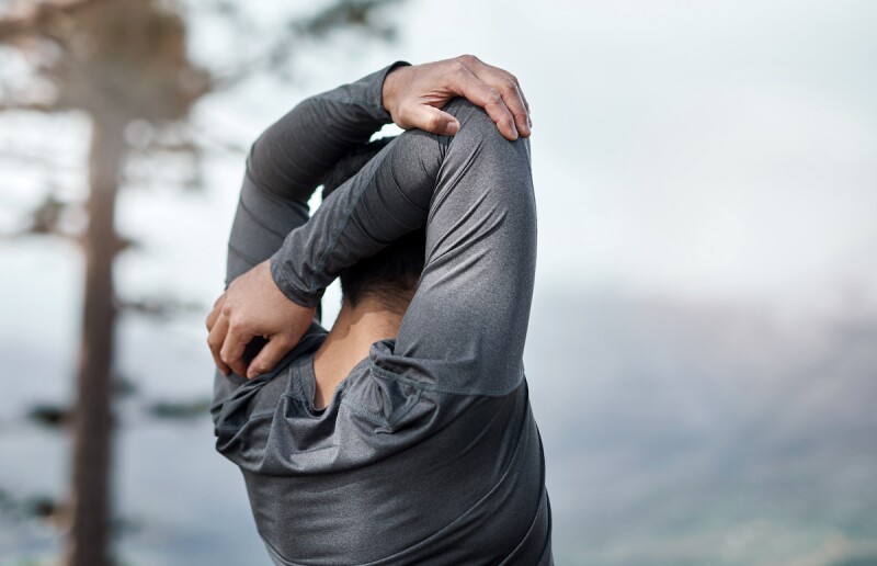 Man doing a tricep stretch 