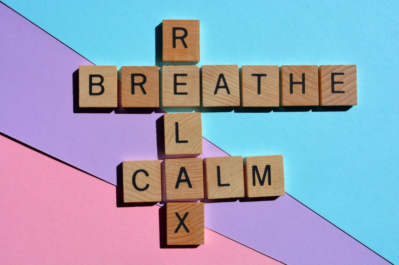 Scrabble tiles that say breathe, calm, and relax