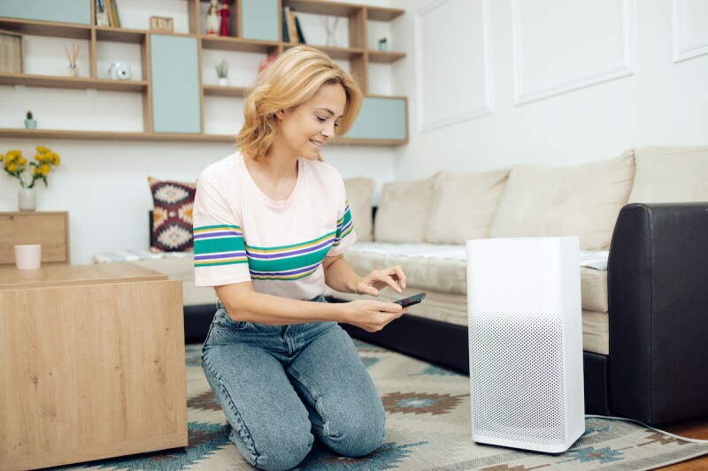 Woman using an air purifier for her allergies at night