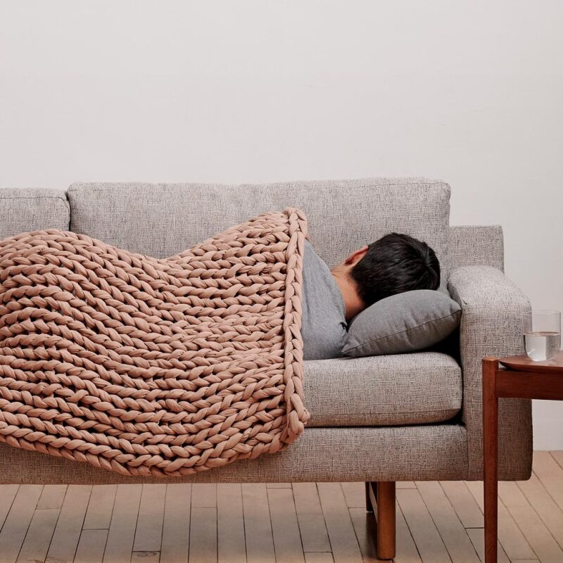 Man sleeping under a Bearaby weighted blanket