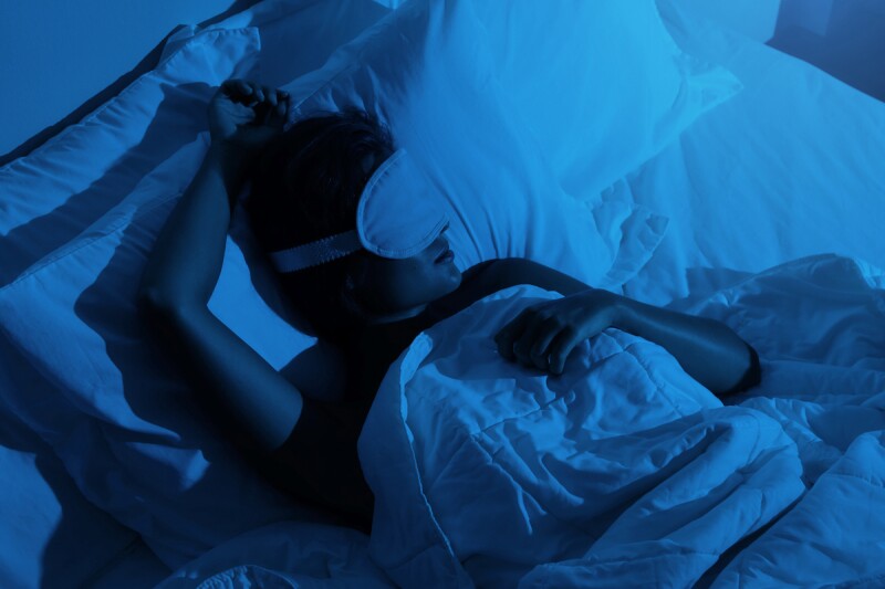 Woman with a sleep mask on to get high quality sleep