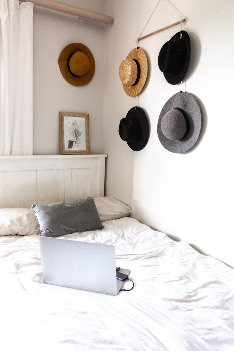 Hats hanging on a wall as decoration in a bedroom