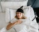 woman sleeping wearing a cooling headband