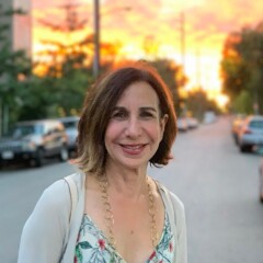 Shelley Levitt's author headshot, on a street in front of a sunset.