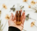 Close up of a hand holding essential oil spray
