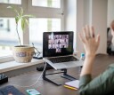 Person using a laptop to have a video meeting at home.