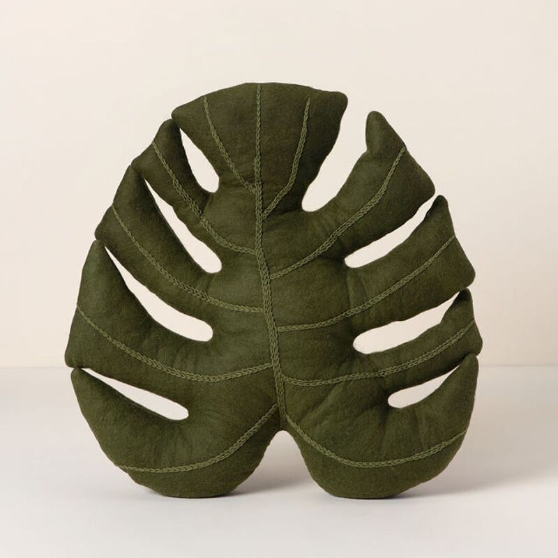 Monstera throw pillow, a great gift for sleep and relaxation.