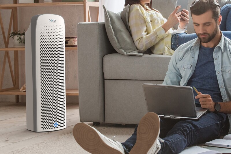 People working in the living room with a Pure Enrichment Air Purifier