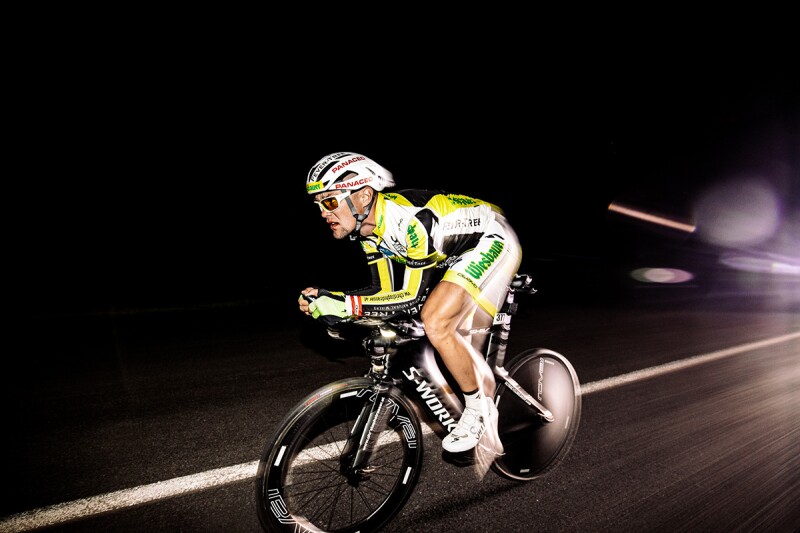 A cyclist whirs past the photographer on his bicycle, creating a sonic visual effect as he transverses the road. Race Across America, or RAAM, does not make time for its athletes to take breaks -- even for sleep.
