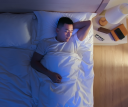 top view of asian man sleep well with smile at night.