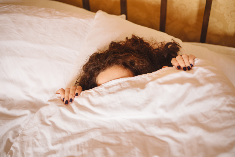 Well-rested Blonde Woman Enjoying Happy Morning, Stretching in Bed