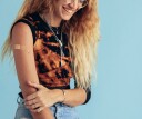 Girl with bandaid on her arm, post-vaccine shot, smiling