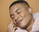 Man looking calm with ear plugs and travel pillow