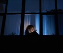 Girl texting on her phone in the middle of the night, wide awake